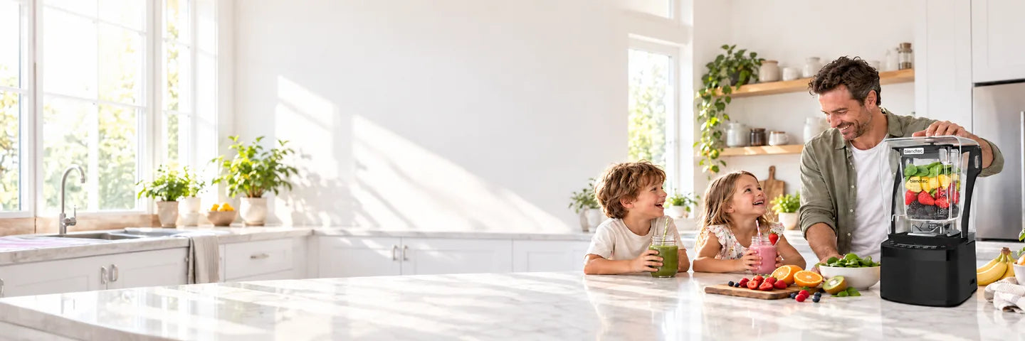 A dad and two kids making fruit smoothies with a Blendtec Professional 800 blender in a bright, sunny family kitchen